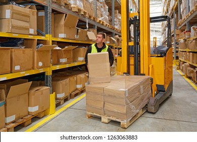 Order Picking Worker With Box In Fulfillment Warehouse