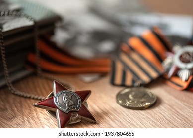 Order of Red Star on blurred background with St. George's ribbon and medals. 9 MAY greeting card. Transcription " Workers of all countries, unite USSR
