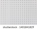 orderly holes or dot rows and columns on white pegboard wall.