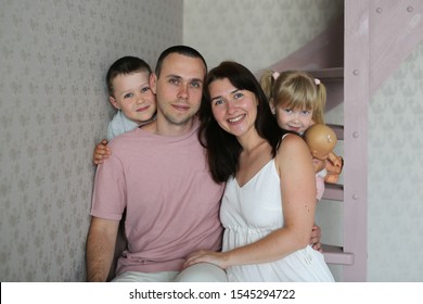 An ordinary Caucasian family with two siblings, a classic portrait. Brother and sister with dad and mom, family portrait - Shutterstock ID 1545294722