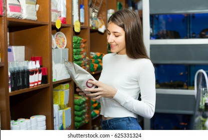 Ordinary Female Customer Buying Dry Food For Pets At The Pet Store