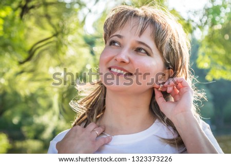Ordinary girl with plump cheeks in the Park in a Sunny summer day