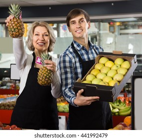 ordinary grocery staff selling fresh fruits at farm food store