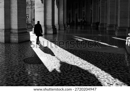 An ordinary man captured while crossing a sunlight beam. 