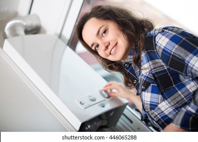 Ordinary Smiling Girl Using Heating Water System At Home