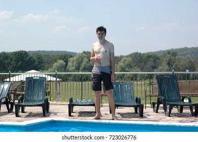 An Ordinary Tall Guy Is Standing By The Pool.