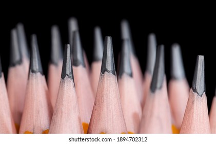 ordinary yellow wooden pencil with gray soft lead for drawing and creativity, close-up of pencils after sharpening, pencil made of natural materials