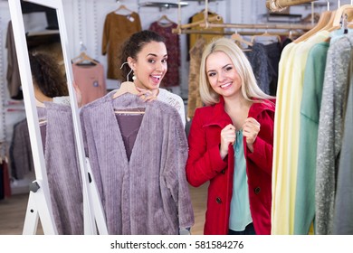 Ordinary Young Women Shopping Seasonal Winter Outwear At The Apparel Store