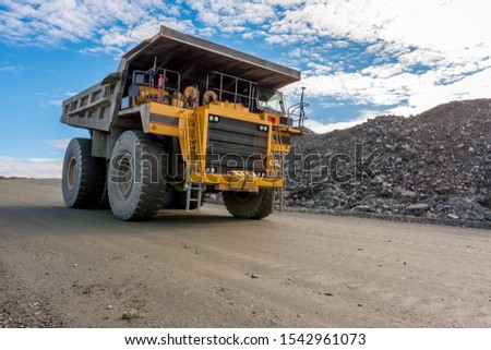 ore loading by the excavator, ore transportation by heavy trucks