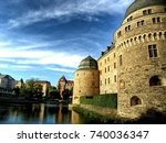 Orebro Castle in Scandinavian Sweden Surrounded by Water and Blue Sky 