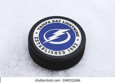 OREBRO, SWEDEN - MARCH 6, 2018: Ice hockey puck with Tampa bay lightning logo outdoor on ice in Orebro, Sweden 