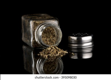 Oregano Shaker On Black Background.