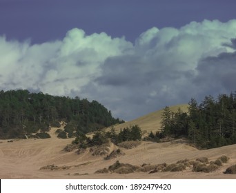 Oregon Coast Sand Dunes With Storm Clouds On Horizon.
