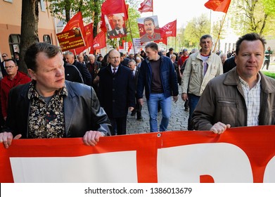 Orel, Russia, May 01, 2019: Labor Day celebration. Crowd of people marching with red flags along the street