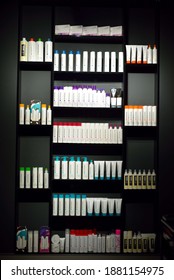 Orenburg, Russia - December 19, 2020: Black Shelf With Hair Care Products In A Beauty Salon. Modern Beauty Salon Interior. Original Cosmetics On Shelves Paul Mitchell. Vertical Photo Of A Beauty Salon