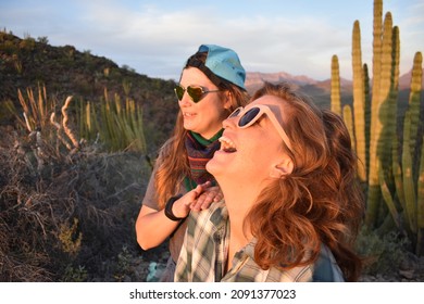 Organ Pipe Cactus National Monument, Arizona, USA - March 5, 2020: Two friends watch the sunset with the cacti in the Sonoran Desert