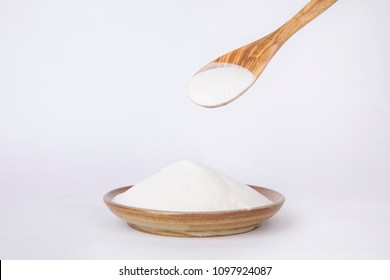 Organic Acacia Fiber Powder With Wooden Spoon Isolated On White Background.