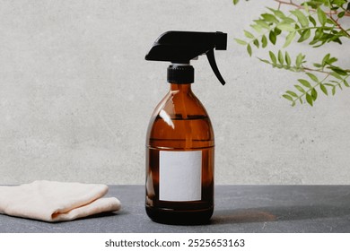 Organic amber spray bottle mockup with blank label on dark surface. Organic and natural cleaning supplies. Eco-friendly cleaning. Organic cleaner spray bottle mockup on gray surface. - Powered by Shutterstock