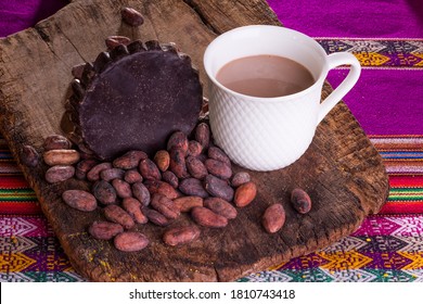 
Organic Artisan Chocolate Bar In Mug, On Wooden Background With Cocoa Beans From The Andes Of Peru