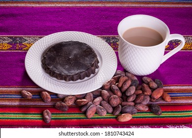 
Organic Artisan Chocolate Bar In Mug, On Wooden Background With Cocoa Beans From The Andes Of Peru