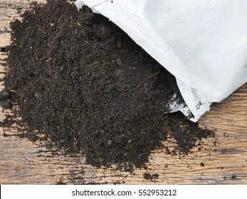 Organic Back Soil With Bag For Planting On Wood Background