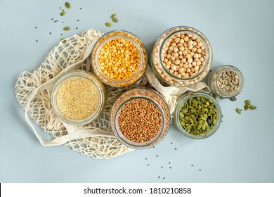 Organic bio bulk products. Foods storage in kitchen at low waste lifestyle. Cereals and grains in glass jars on table. Eco friendly shopping in plastic free grocery store.