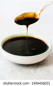 Organic Black Cane Sugar Molasses Dripping From Spoon