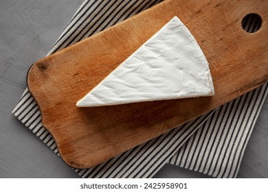 Organic Brie Cheese on a wooden board, top view. Flat lay, overhead, from above. - Powered by Shutterstock