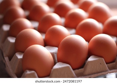 Organic Brown eggs in tray or egg box. Poultry Chicken eggs in carton for grocery or breakfast. Protein diet container in kitchen. Hen farm eggshells collected arranged packaged for sale. - Powered by Shutterstock