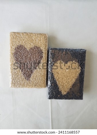 Organic brown rice packed in a heart -shaped form on white background