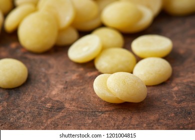 Organic Cacao Butter Buttons (wafers) On Rustic Background