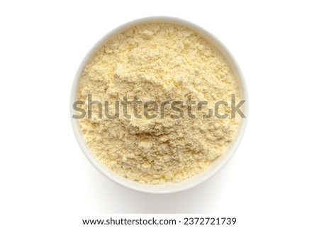 Organic Corn Flour (Zea mays) or Makka Flour in a white ceramic bowl. Isolated on a white background. Top View