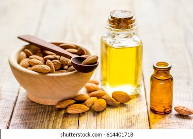 organic cosmetic with almond extract on table background