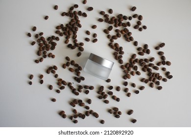 Organic Cosmetics With Coffee Extract. Skincare Cosmetic Product And Coffee Beans. Coffee Beans And Cosmetic Butter In Jar On White Background. Flat Lay Top View Copy Space Mockup