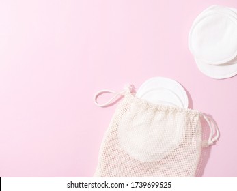 Organic Cotton Pads With String Bag On Pink Background. Zero Waste, Reusable, Eco, Makeup Remover And Washing Concept. Pattern, Hard Light, Flat Lay, Copyspace