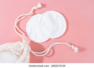 Organic Cotton Pads With String Bag On Pink Background. Zero Waste, Reusable, Eco, Makeup Remover. Shadows, Hard Light, Flat Lay