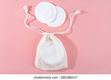 Organic Cotton Pads With String Bag On Pink Background. Zero Waste, Reusable, Eco, Makeup Remover. Shadows, Hard Light, Flat Lay