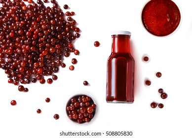 Organic Cranberry Juice In Bottle And Scattered Berries On White Background. Top View