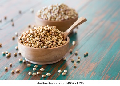Organic Dried coriander seeds (Coriandrum sativum) in wooden bowls with spoon on colored rustic background. Healthy eating, Indian spice, flavoring, vitamin. - Powered by Shutterstock