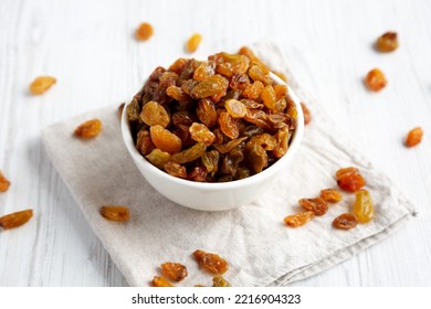 Organic Dried Raisins In A White Bowl, Side View. Close-up.