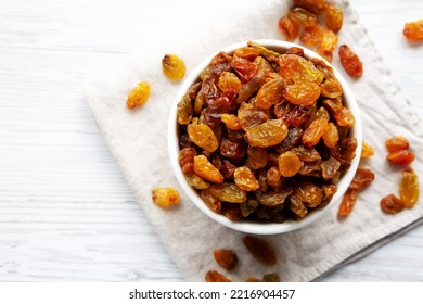 Organic Dried Raisins In A White Bowl, Top View. Overhead, From Above, Flat Lay. Copy Space.