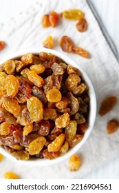 Organic Dried Raisins In A White Bowl, Top View. Overhead, From Above, Flat Lay. 