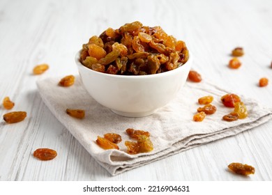 Organic Dried Raisins In A White Bowl, Side View. Close-up.