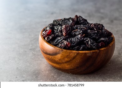 Organic Dried Raw Raisins In Wooden Bowl.