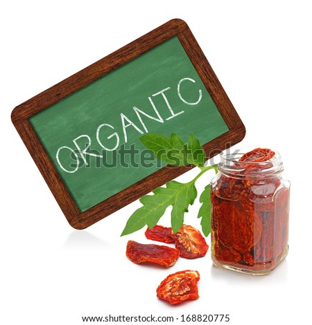 Organic dried tomatoes with chalkboard sign on white background