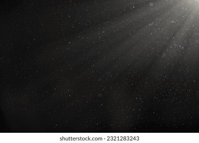 Organic dust particles floating in light ray on black background. glittering sparkling glowing. - Powered by Shutterstock