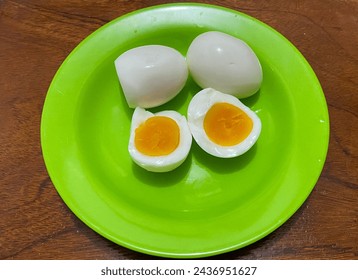 Organic eggs have been boiled on a green plate. - Powered by Shutterstock