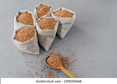 Organic farming concept. Five small sacks with buckwheat with useful properties, can be cooked for garnish. Healthy nutrition concept - Shutterstock ID 1398350468
