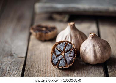 Organic Fermented Black Garlic on wooden table