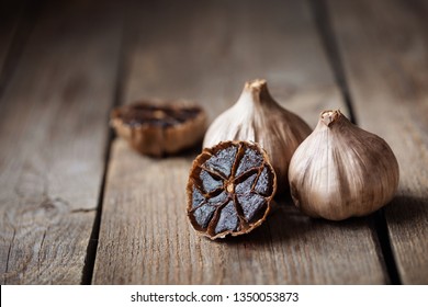 Organic Fermented Black Garlic on wooden table